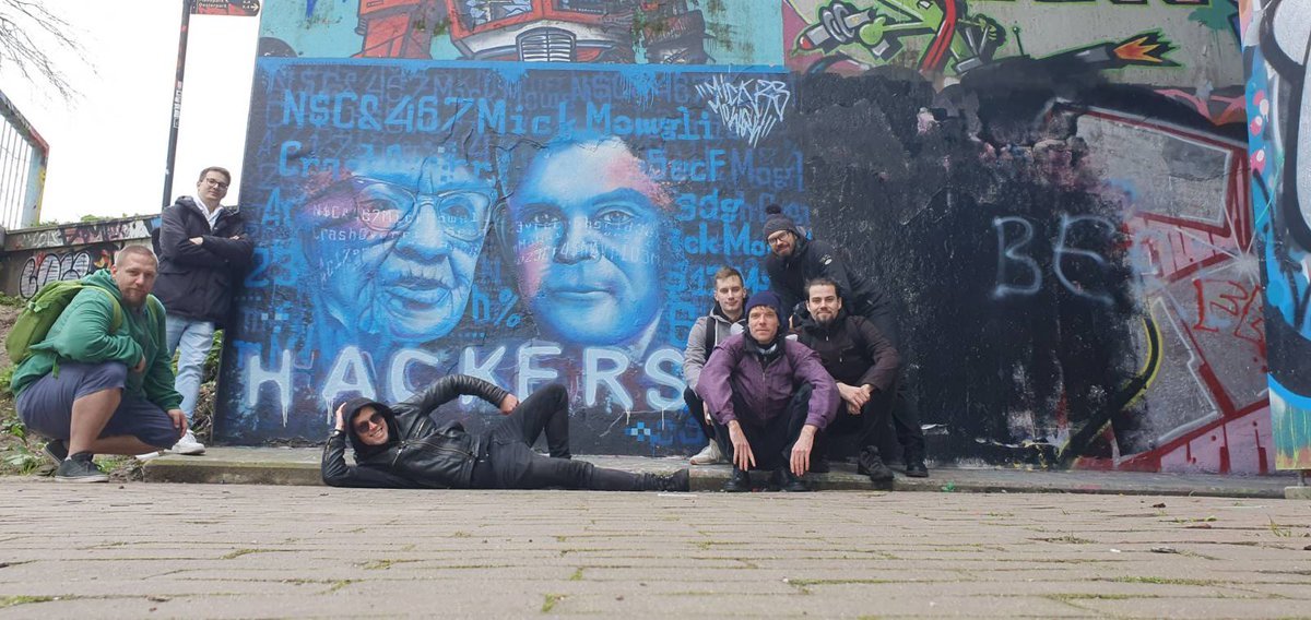 Crashoverride team in front of the hacker mural